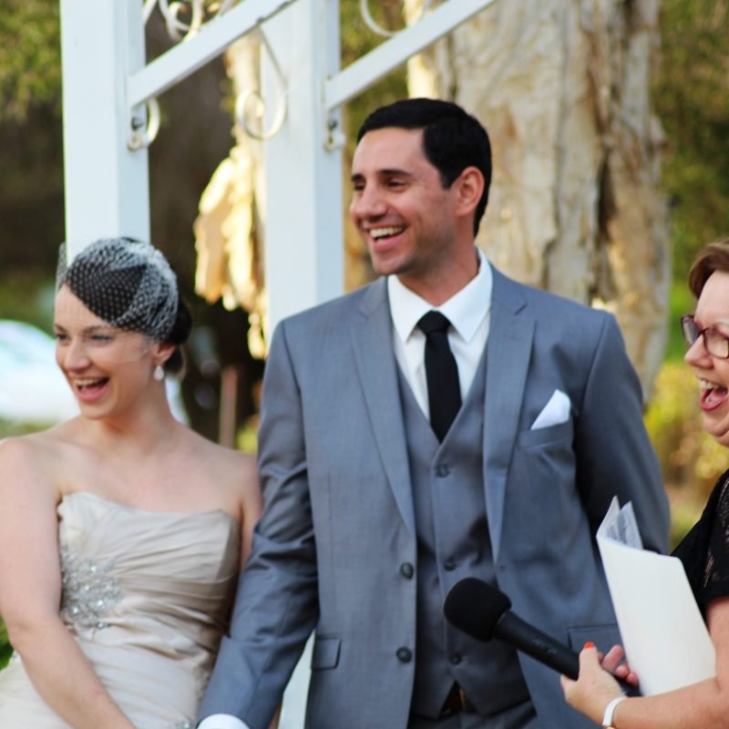 A couple alongside Robyn, smiling and laughing